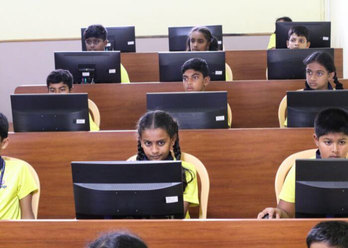 Students engaged in interactive learning at the computer lab in one of the best international schools in North Bangalore.