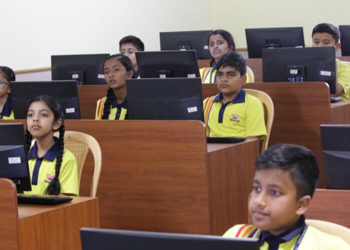 Students participating in a technology-driven learning session in the computer lab of a premier international school in Bangalore.