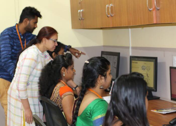 Teacher explaining historical concepts using advanced digital tools in the classroom at NewAge World School, Yelahanka.
