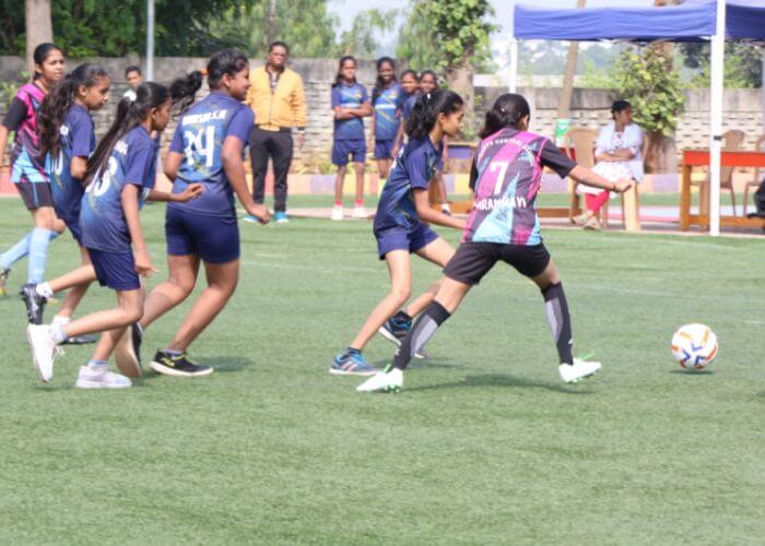Students playing football on the multi-sport field at NewAge World School