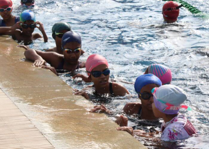 Diverse sports activities like basketball, football, and swimming at the multi-sport facility in North Bangalore.