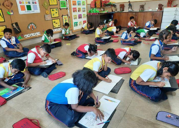 Young learners drawing and coloring during a fine arts activity at NewAge World School's Performing and Fine Arts Studio.