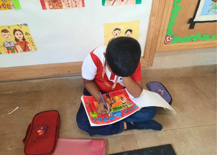 Children focused on creating vibrant artwork during a fine arts class at the Performing and Fine Arts Studio in Yelahanka.