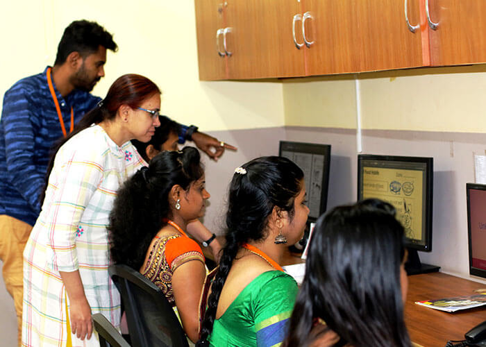 Teachers working on digital learning content in the in-house Department of Excellence at NewAge World School to enhance educational outcomes.