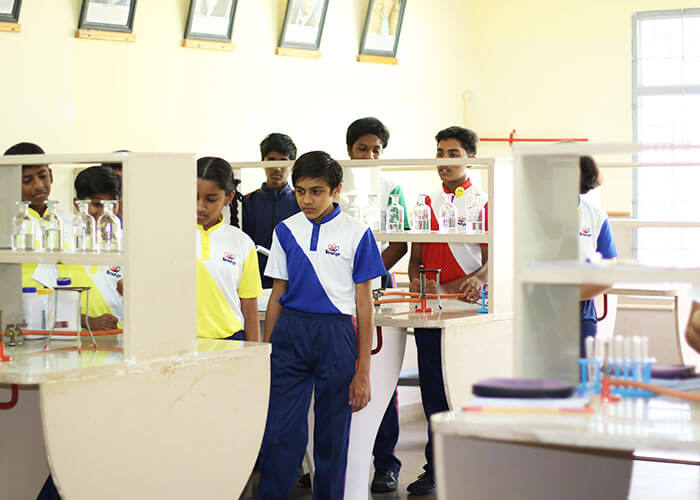 Students exploring advanced science lab infrastructure at NewAge World School to enhance real-life application-based learning.