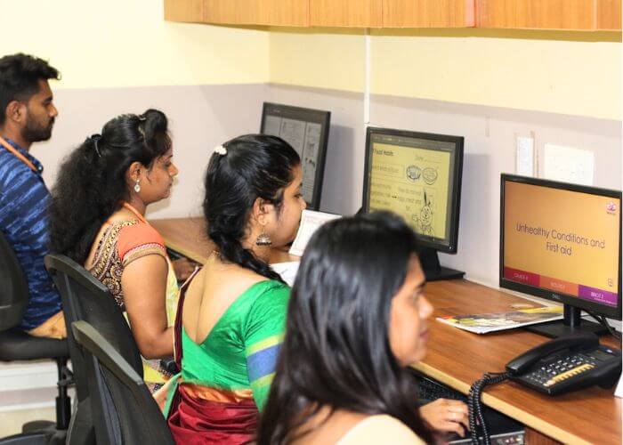 Teachers creating a custom curriculum using innovative learning modules at NewAge World School.