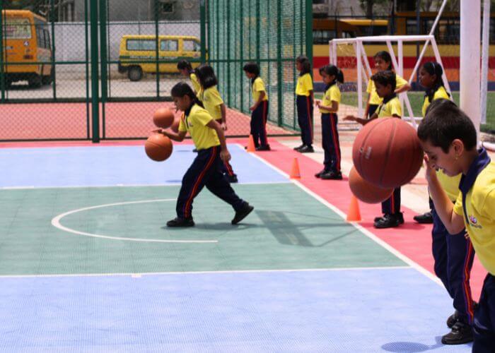 Students enjoying basketball and other sports at the multi-sports facility at NewAge World School, Yelahanka.